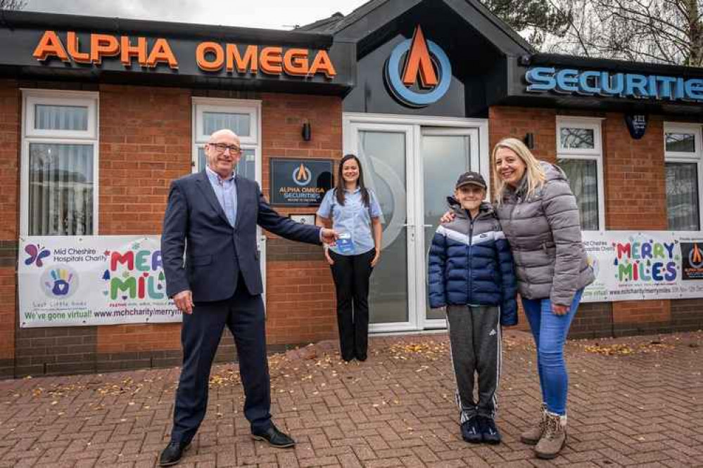 Georgy Capener and his mum Helen visit Alpha Omega in Crewe where Ken Lawton and Loren Mumford present the youngster with a PlayStation voucher.