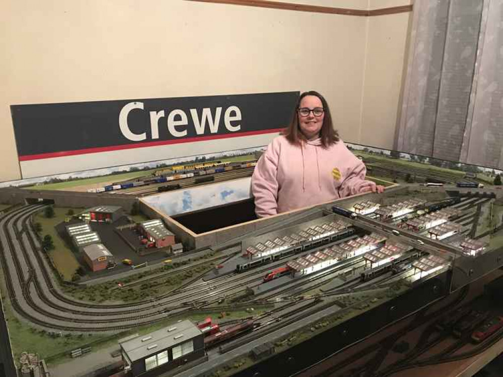 Rachel Cope surveys her handiwork in front of her treasured Crewe Station sign.