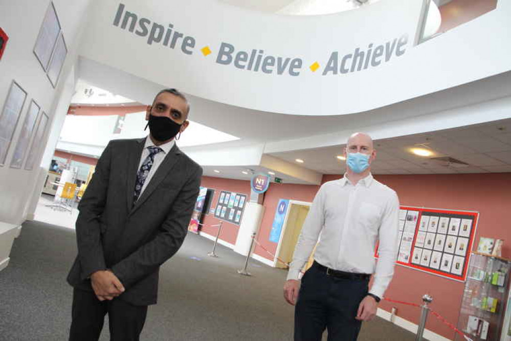 Principal and CEO of Cheshire College, Dhesi (left), with MP Kieran Mullan.