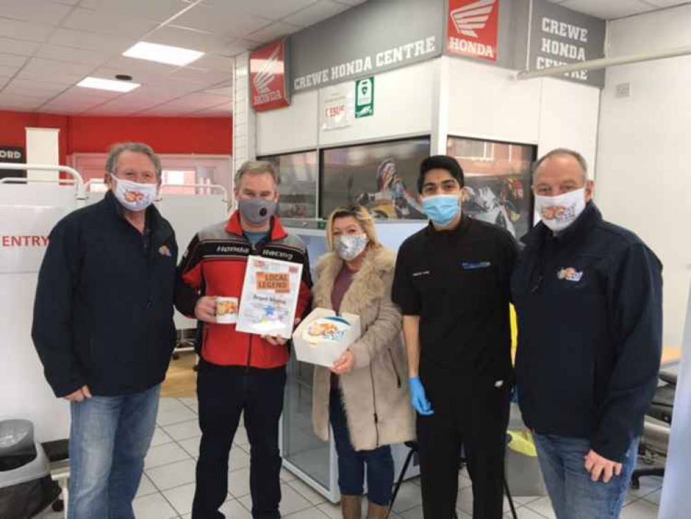 Roger Morris is presented with his award by Cat MD Chris Cadman, Gill Clark of Baked by Gill and presenter Dave Foulkes with Jainil Patel clinical lead.