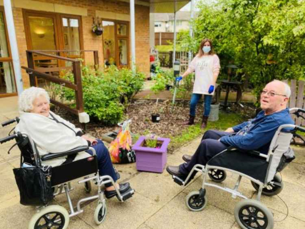 Residents Irene Schofield (left) and Ken Edwards (right) with Amanda James from Belong's experience day team (back).