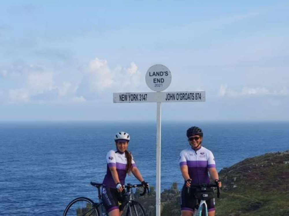 Riders Izzie and Christina set off on their route at Land's End.