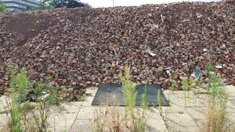 Rubble piled up after the demolition is to be used in the rebuild.