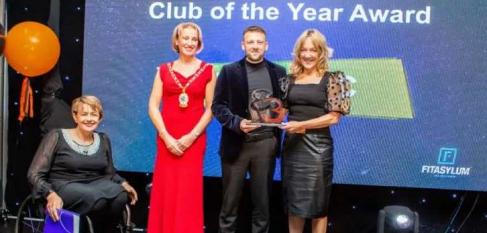 Steve Parker from Crewe FC receives the Club of the Year award from Cheshire East Mayor Sarah Pochin and Baroness Tanni Grey-Thompson.