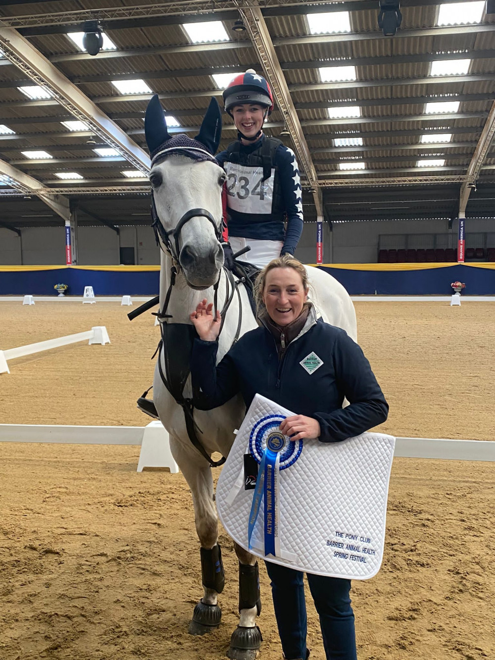 Willow Tulloch receives her rosette from an Animal Barrier Health representative