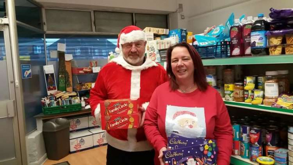 Lodge Jones and Carol Whalley of SYNETIQ with Christmas gifts for Chance Changing Lives.