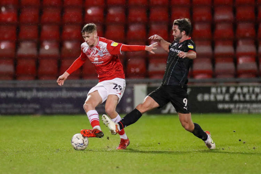 Teenager Connor O'Riordan, here escaping the clutches of Will Griggs, was impressive at the back (Picture credit: Kevin Warburton). for Crewe (Picture credit: Kevin Warburton).