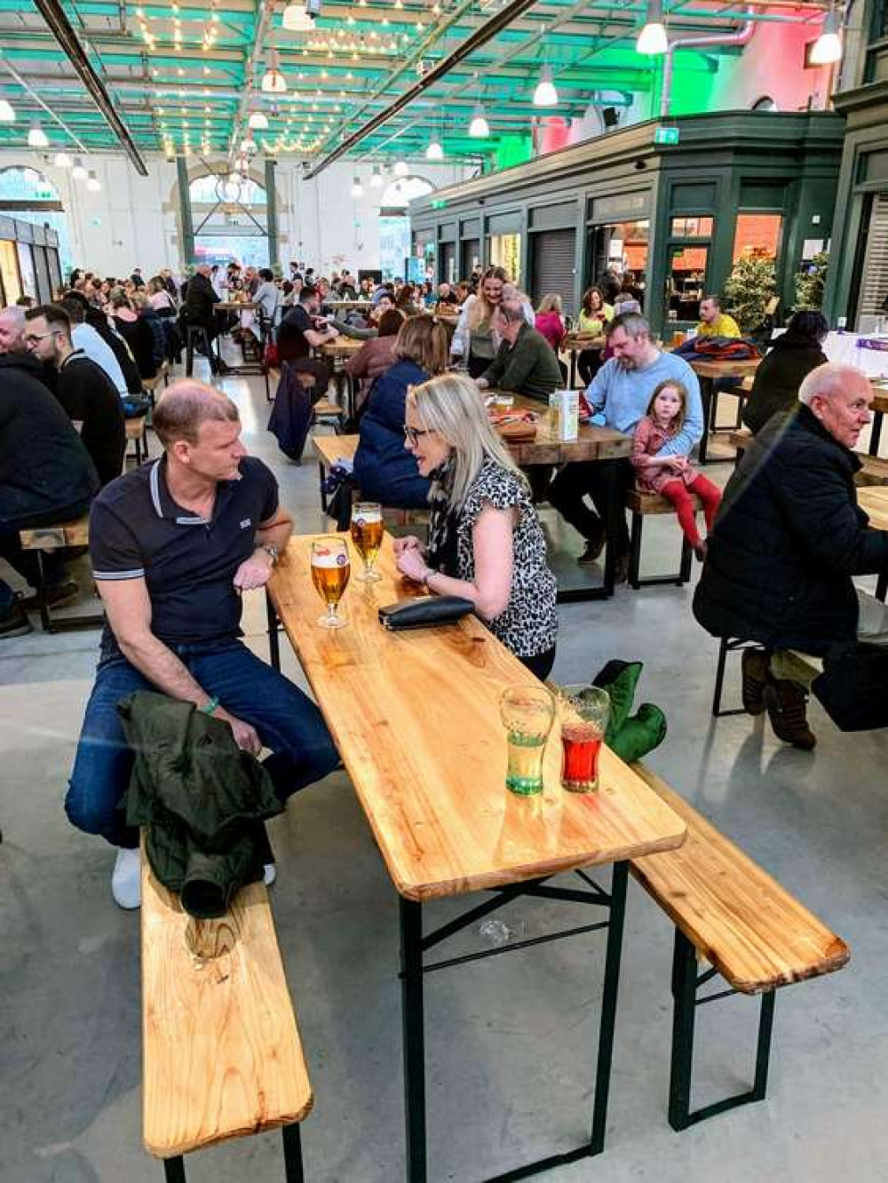 A packed market hall for International Women's Day event.