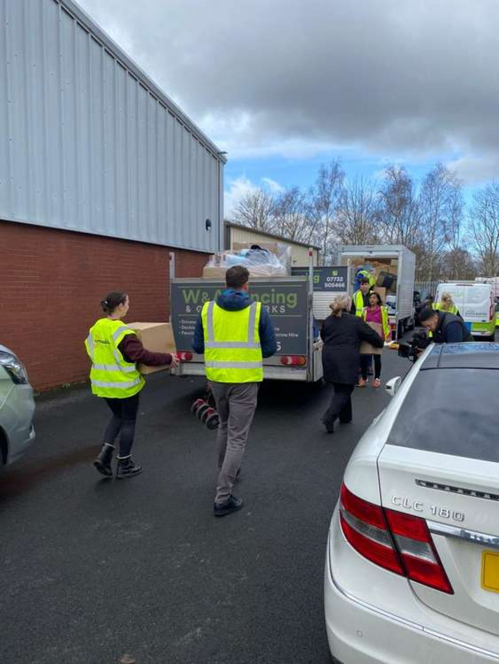 Volunteers loading onto vans.