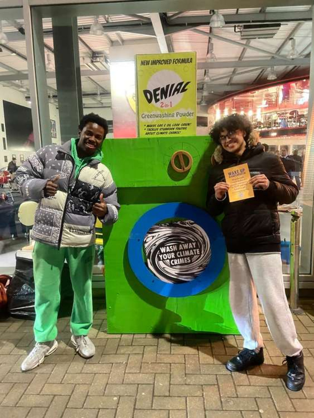 Passers by pose with the placards (credit: Wandsworth Extinction Rebellion)