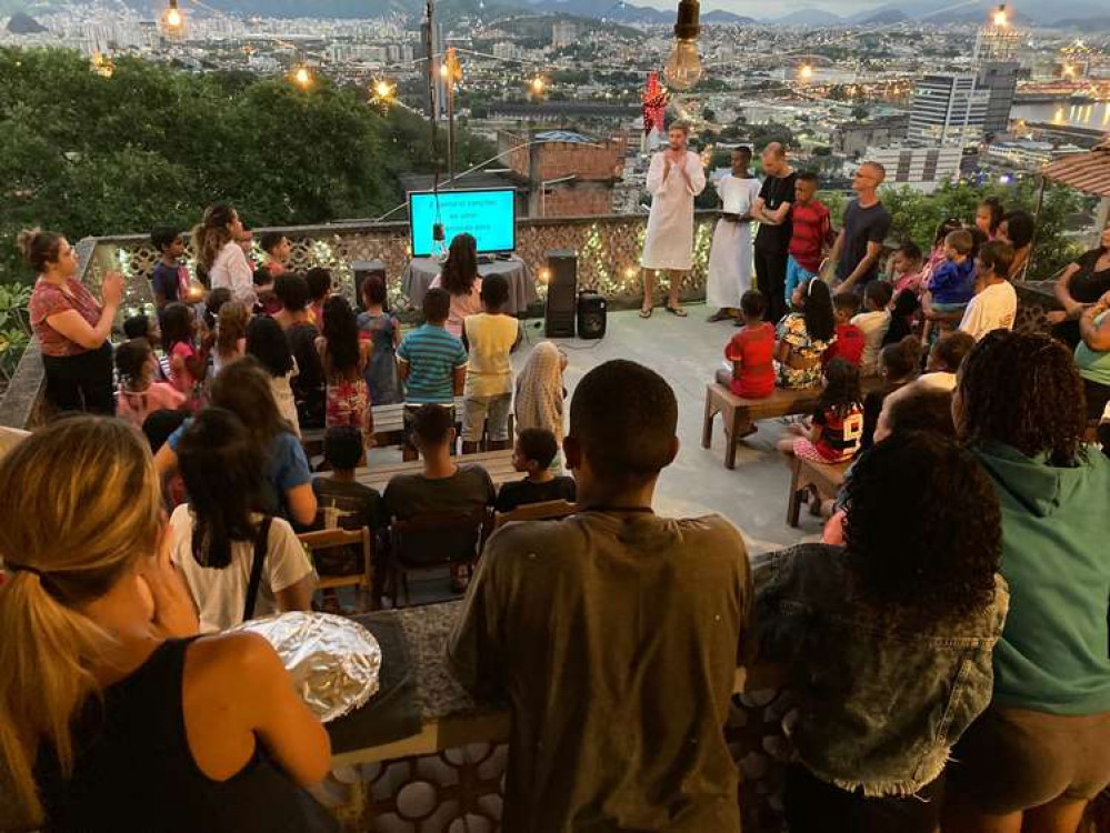 Joel (white robe) singing Christmas songs at Casa Cruzeiro the community centre (Picture credit: Joel Glover)