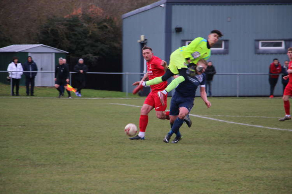 Hadleigh manager Steve Holder wiped out by Swaffham keeper (Picture credit: Ian Evans/Hadleigh Nub News)