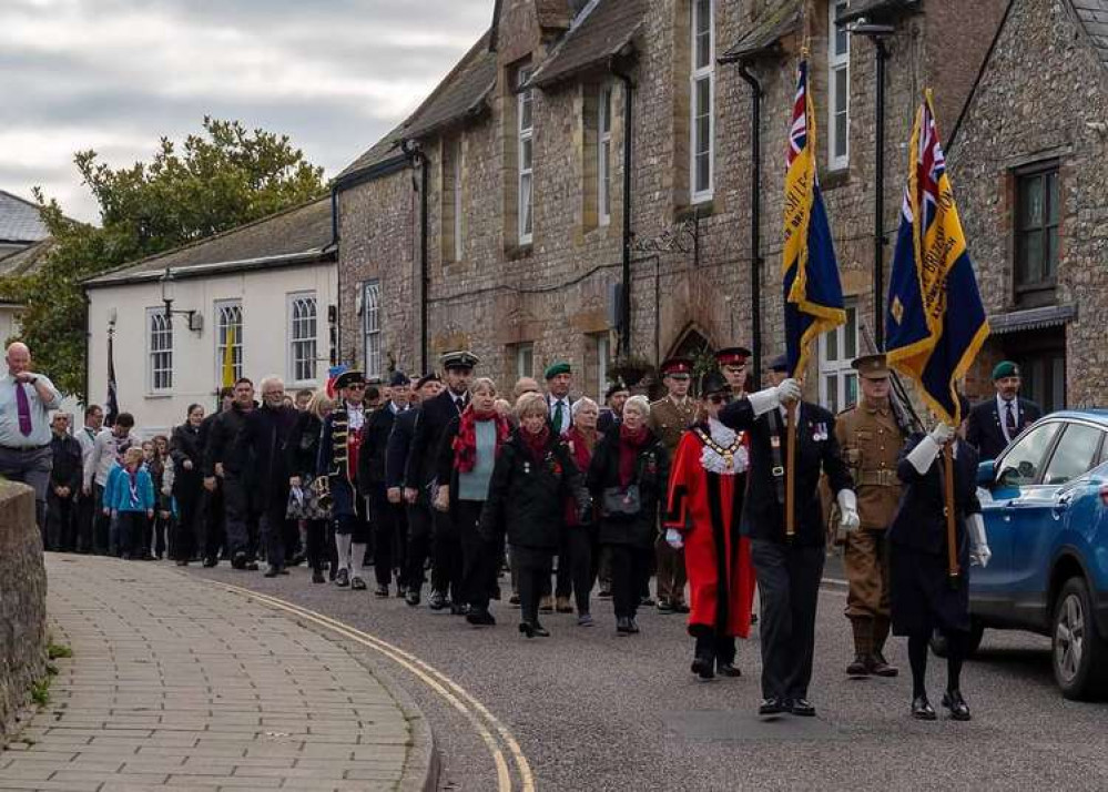 Led by the Royal British Legion standard bearers, the parade makes it way to the war memorial. Photo by James Brown