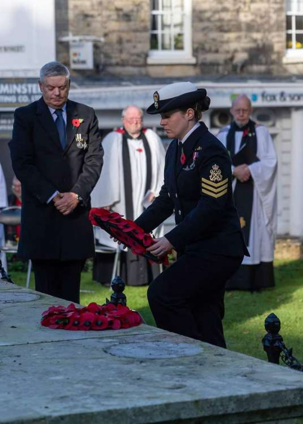 Petty Officer Luena Thomas lays a wreath at the Axminster war memorial on behalf of the Royal Navy Medical Corps. Photo by James Brown