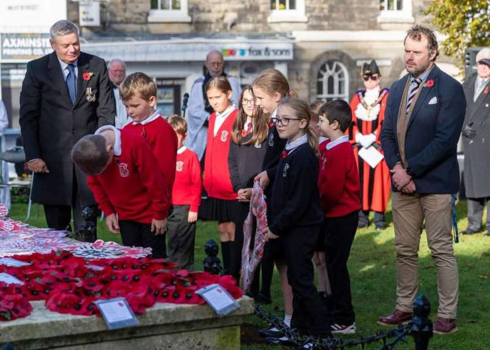 Pupils from Axminster Primary Academy lay a wreath at the war memorial. Photo by James Brown