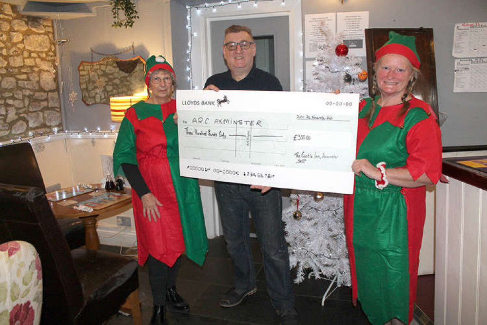 Paul Bocker, landlord of The Castle Inn in Axminster, hands over a cheque for £300 to Suzie McFadzean and Janice Cole from Arc Paul Bocker, landlord of The Castle Inn in Axminster, hands over a cheque for £300 to Suzie McFadzean and Janice Cole from Arc