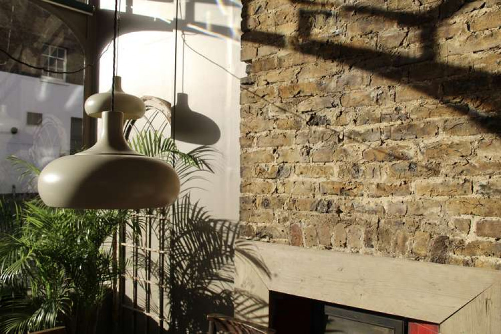 Vast windows onto Clapham High Street allow sunlight to pour in to the restaurant all day (Image: Issy Millett, Nub News)