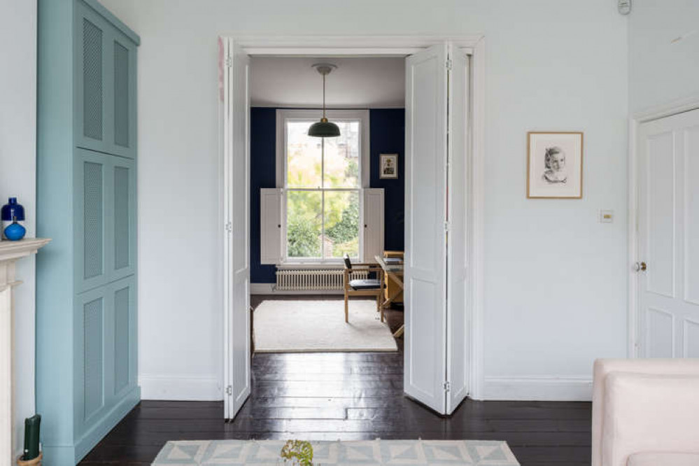 Large folding doors in the middle of the room separate the double reception room (Image: The Modern House)