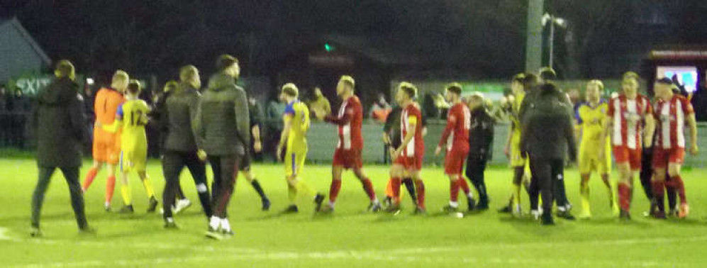 Hullbridge keeper Lewis Greene being held back before being red carded (Picture credit: Felixstowe Nub News)