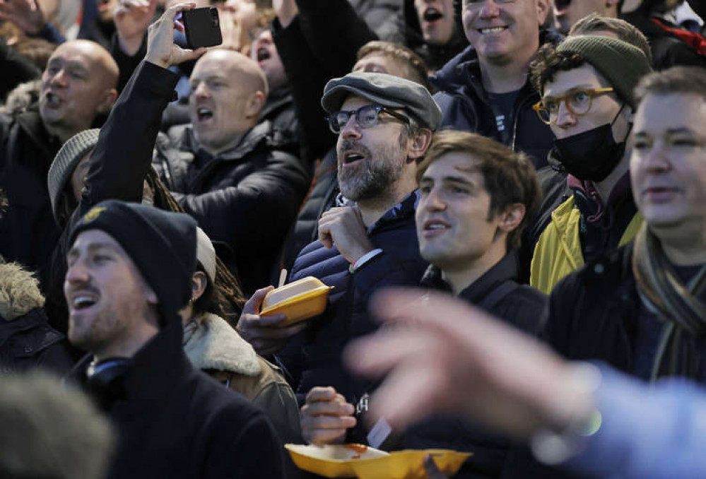 Jason with box of chips and co-star Phil Dunster on his left (Credit: Tom Jenkins/Guardian/eyevine)