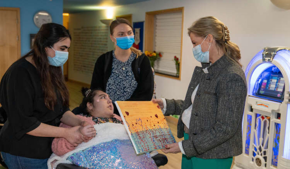 Humairaa and her sister present the Countess with a Valentine's Day canvas (Image: Shooting Star Children's Hospices)