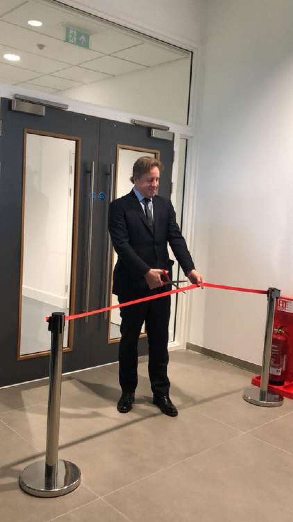 Yeovil MP Marcus Fysh cuts the ribbon at the official opening