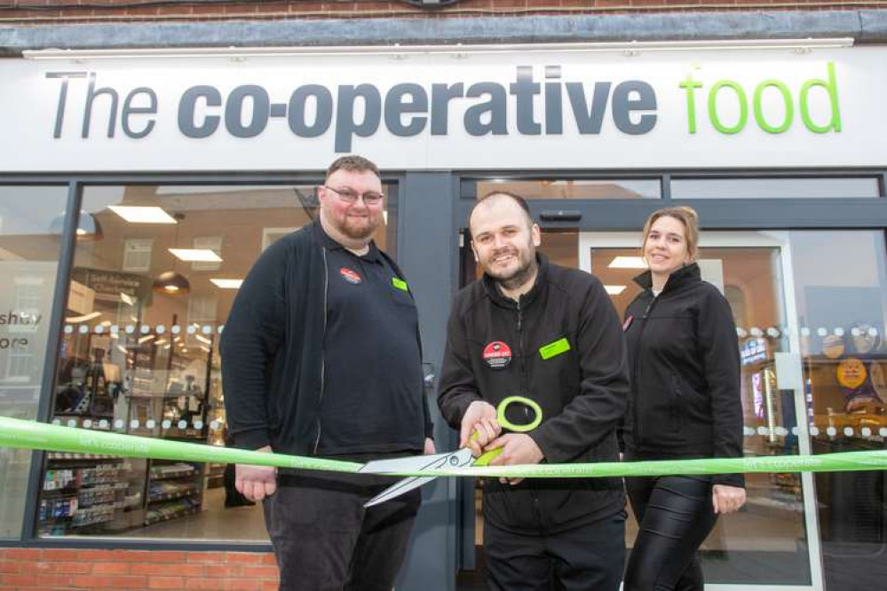 Store Manager Chris Watson (centre) and colleagues cut the ribbon on the new Central England Co-op in Market Street, Ashby