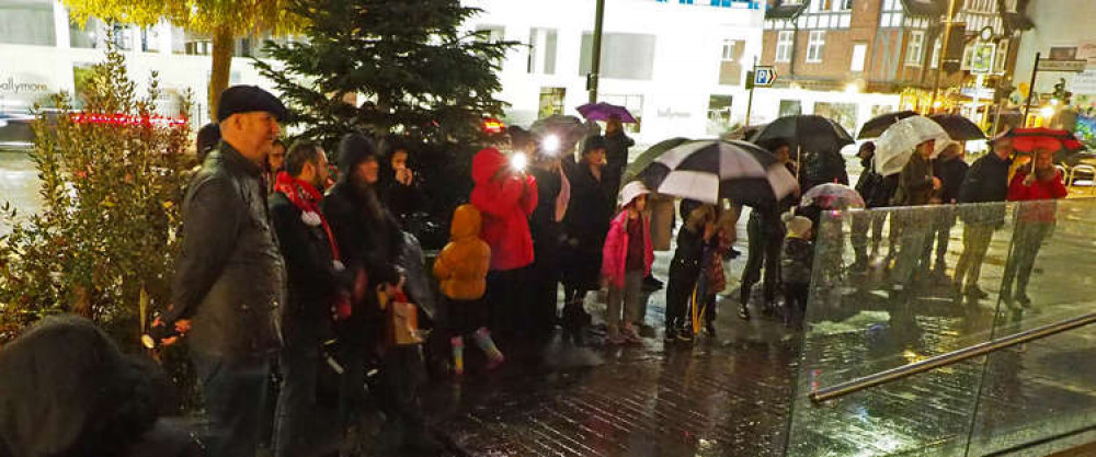 Crowds gathered in the rain to watch the Brentford School for Girls Choir perform. (Image: Eric Baker)