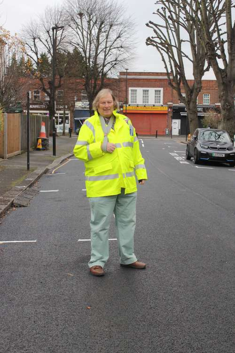 Cllr Guy Lambert inspecting the new road surface after work was completed. (Image: Hounslow Council)