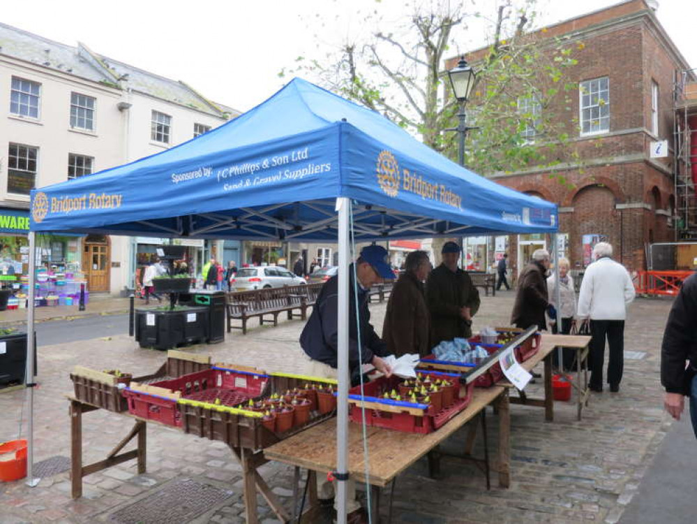 Rotarians selling the hyacinths in Bucky Doo for the club's charity funds