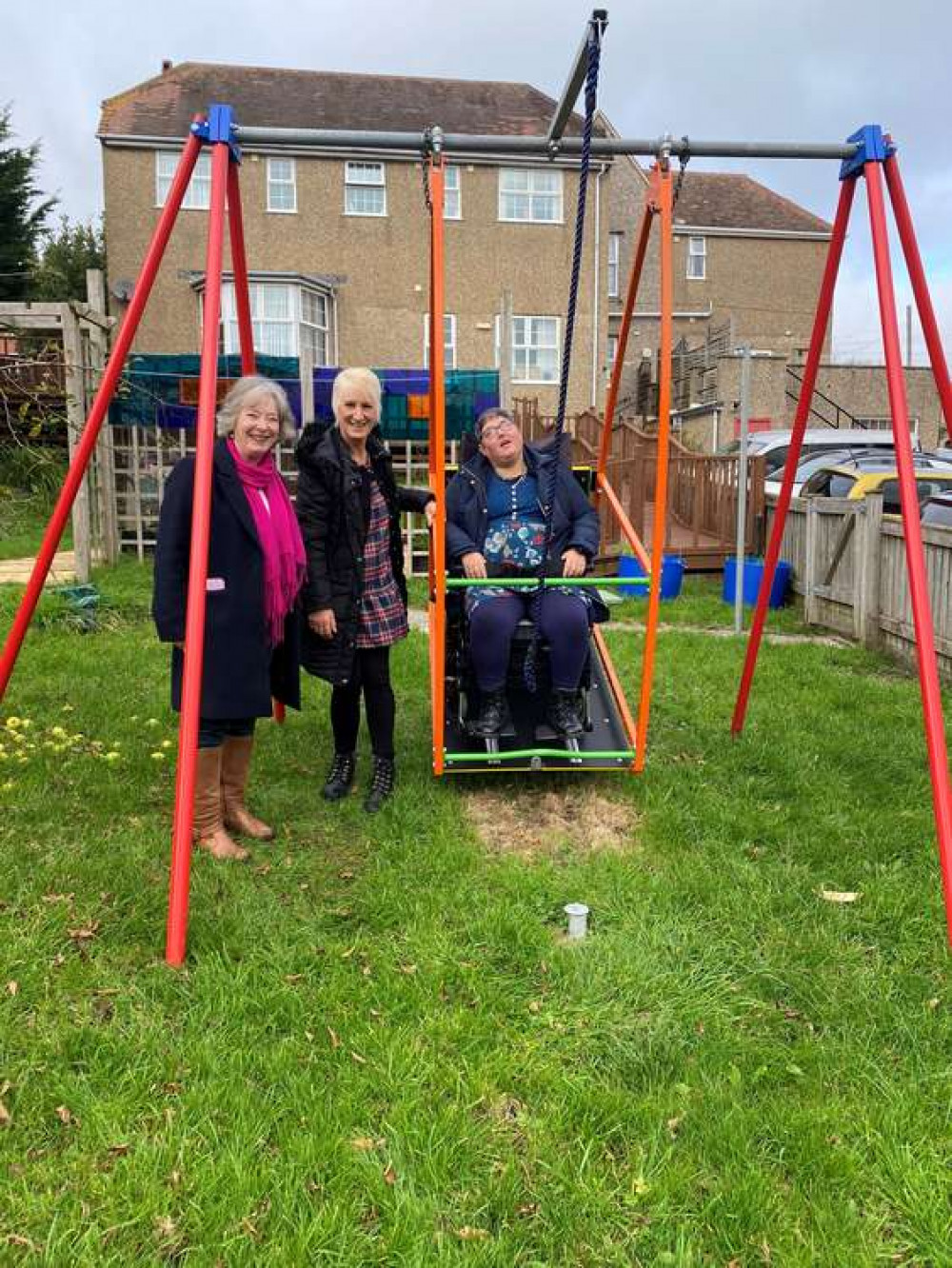 Rachael Hallett enjoying time on the wheelchair swing with her personal assistant Jane and West Dorset Mencap chairman, Linda Simpson