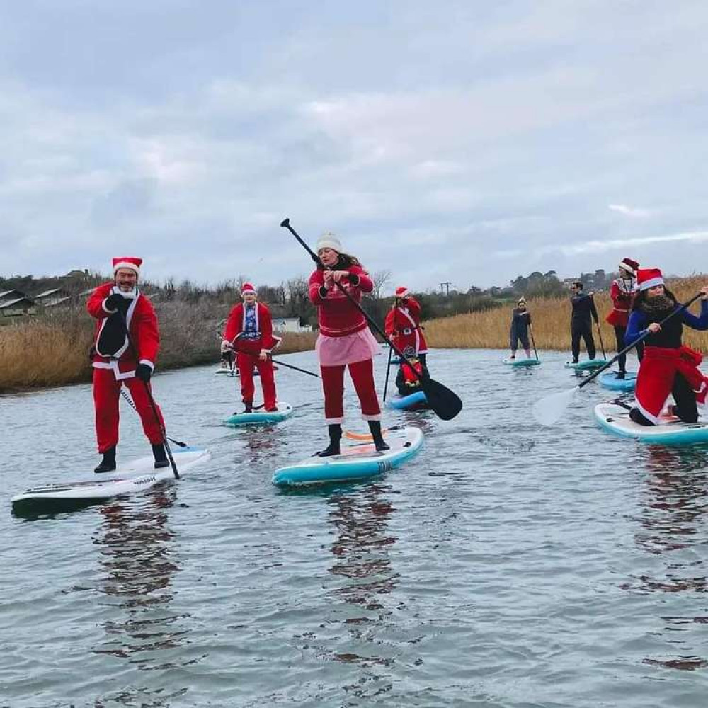 Santa paddle boarders in West Bay raise more than £500 for Action for Children