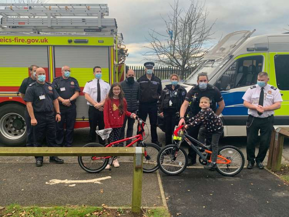 Representatives from Leicestershire Police, Leicestershire Fire and Rescue and the North West Leicestershire Community Safety Partnership Chair, Cllr Andrew Woodman, present Matty and Tazmine with their bikes.