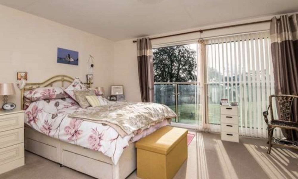 The double bedroom has a Juliet balcony and en-suite bathroom (Fulfords)