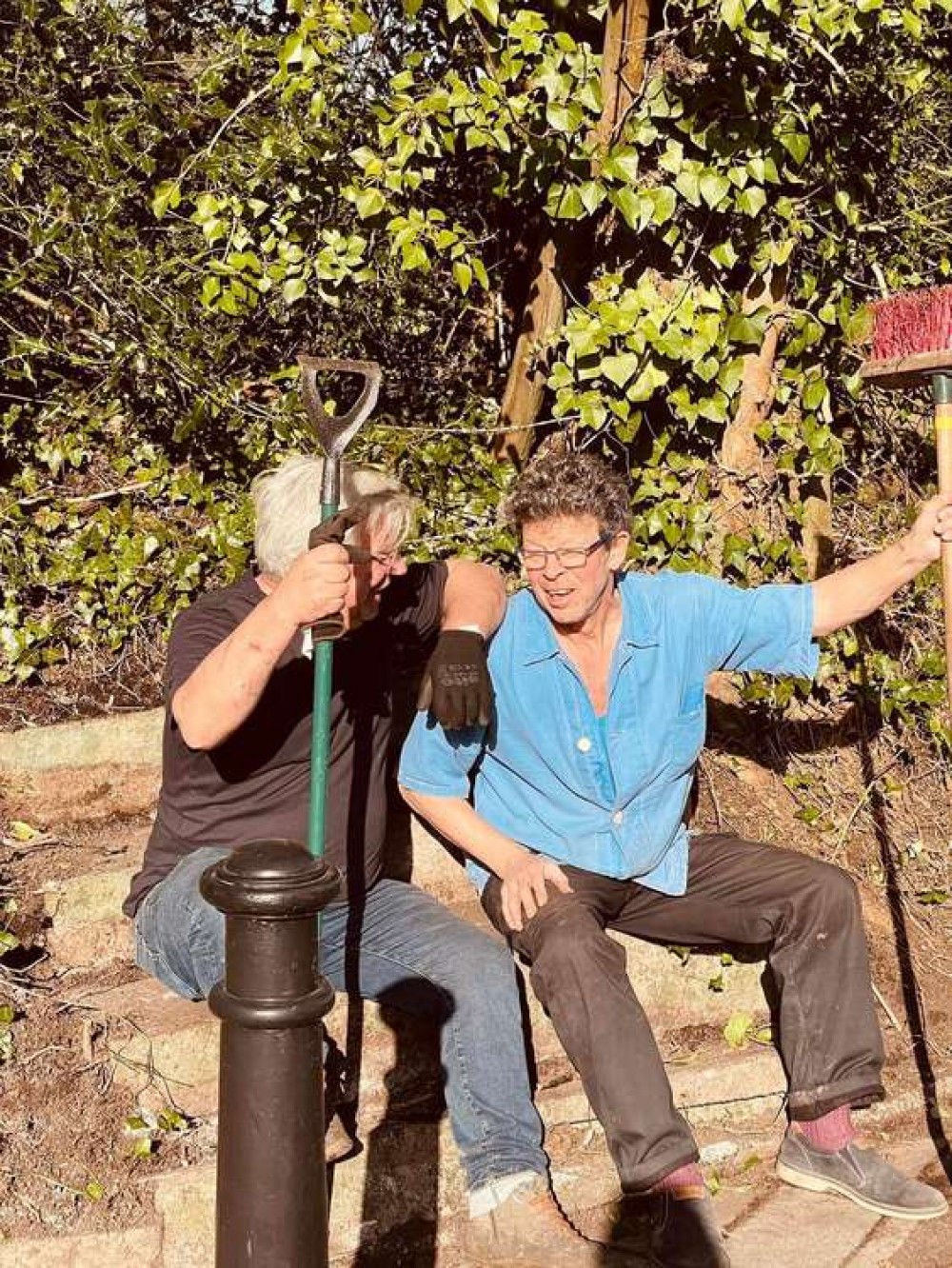 Two tired men on the new found steps to nowhere on Berkley Road in Frome