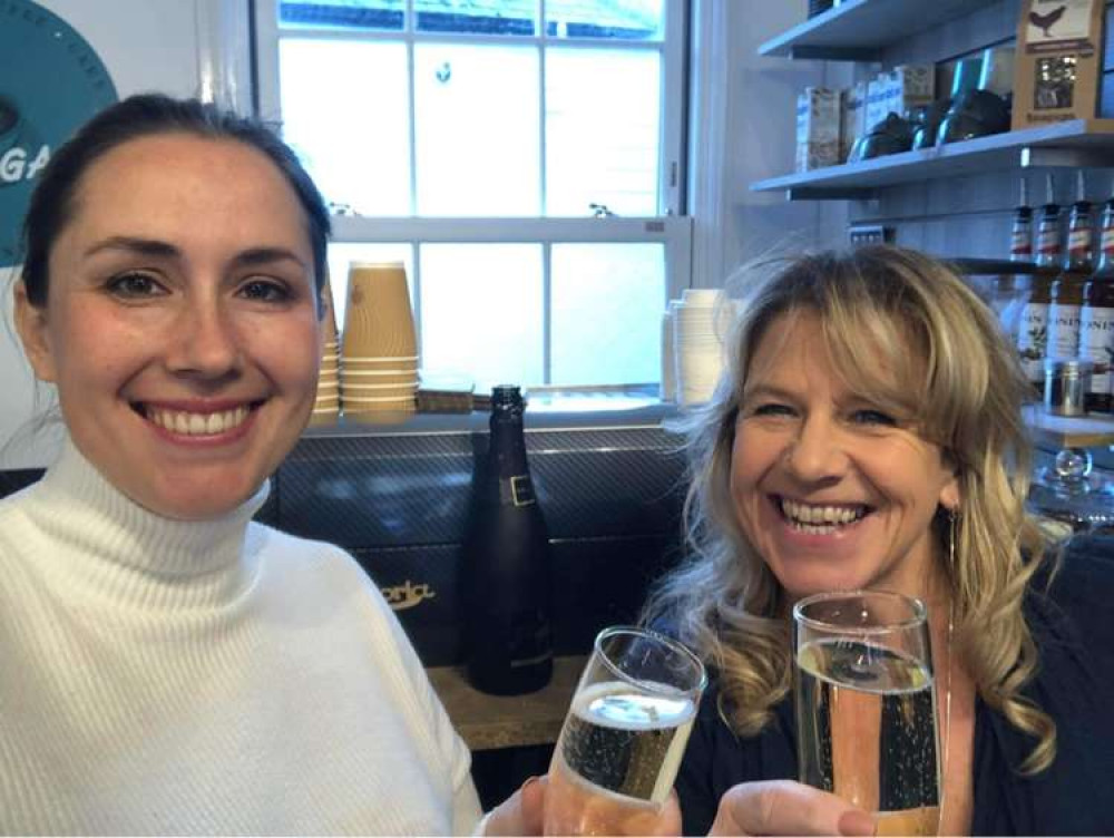 Lucy and Paula raising a glass to the opening.