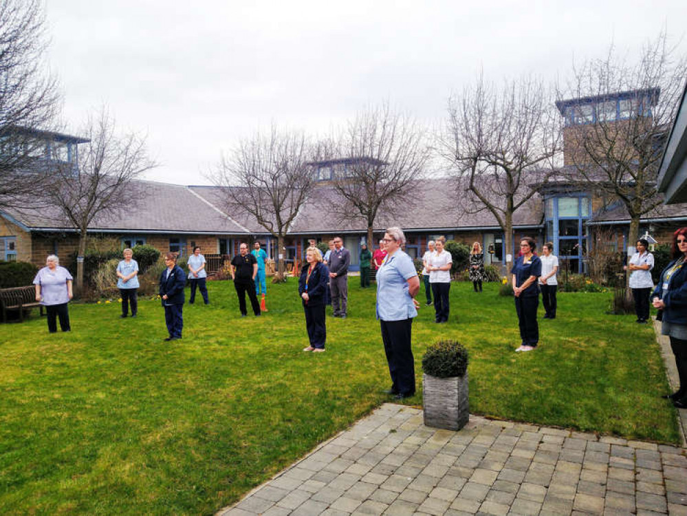 An image of staff observing a minutes silence at a previous reflection event.