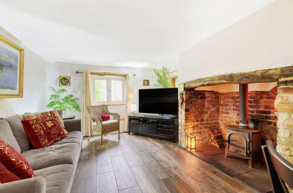 The cottage features a cosy sitting room with inglenook fire. Credit: Bradleys