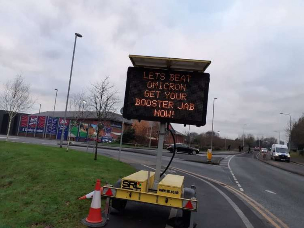 Sign greeting motorists driving through Sandbach urging people to get their booster