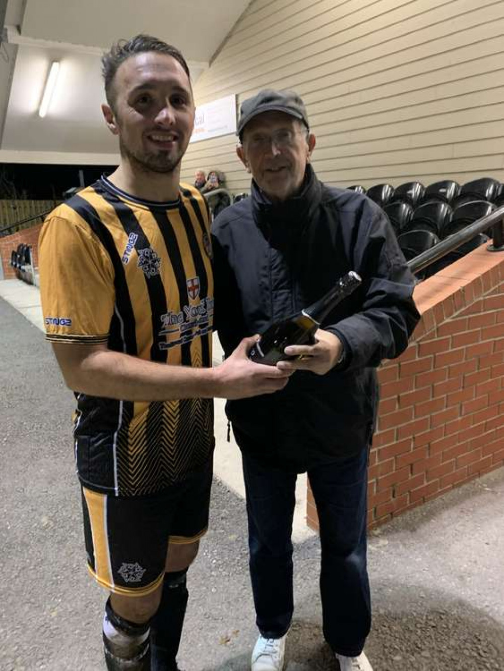 Axminster News sports editor Philip Evans presents Jamie Price with the man-of-the-match award after Axminster Town's 1-0 win over Hinton Town Axminster News sports editor Philip Evans presents Jamie Price with the man-of-the-match award after Axminster Town's 1-0 win over Hinton Town