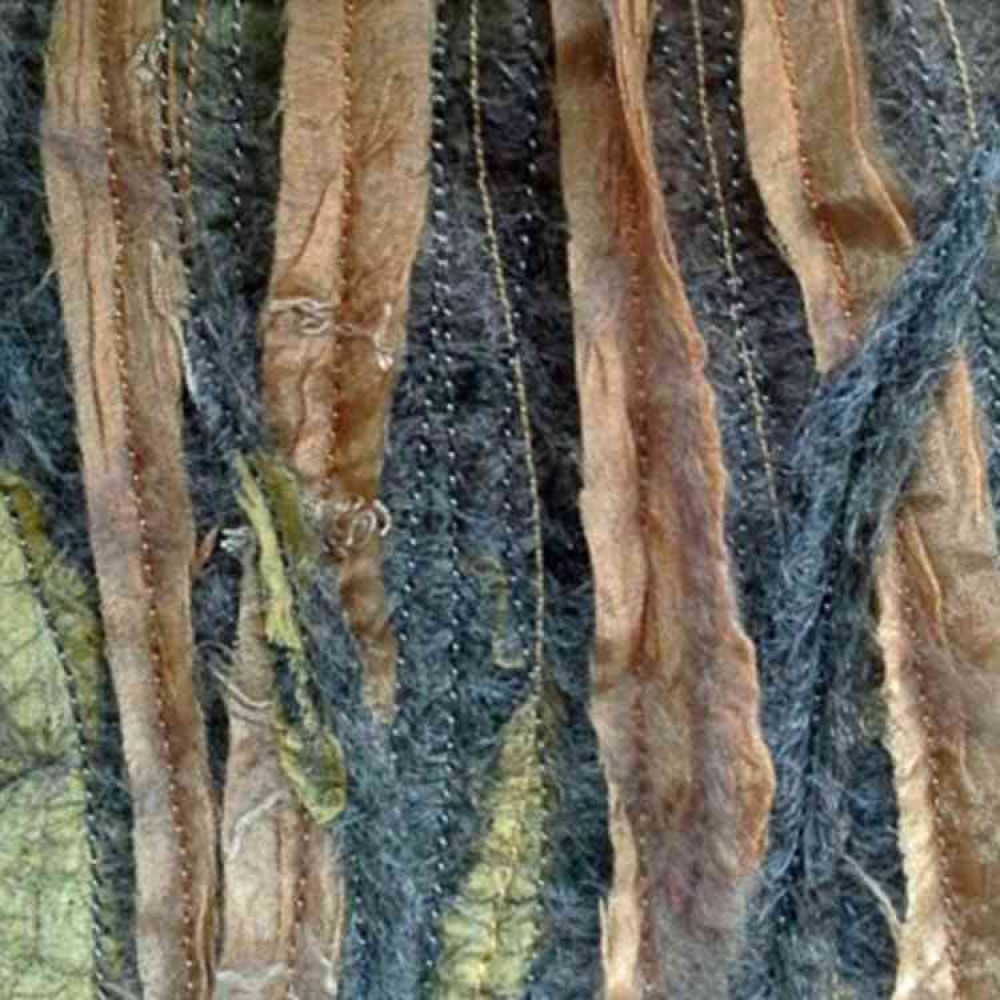 A felt work piece with vertical lines of stitching. A felt work piece with vertical lines of stitching.