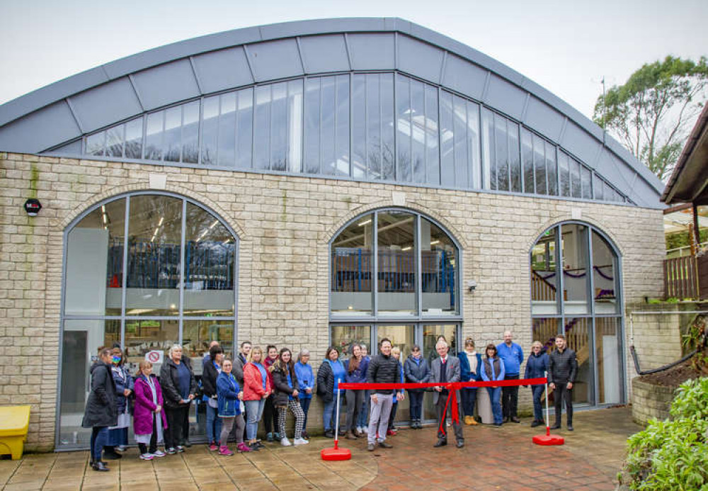 Michael Pritchard, chairman of Peco, cuts the ribbon at the new factory space, watched by staff members Michael Pritchard, chairman of Peco, cuts the ribbon at the new factory space, watched by staff members