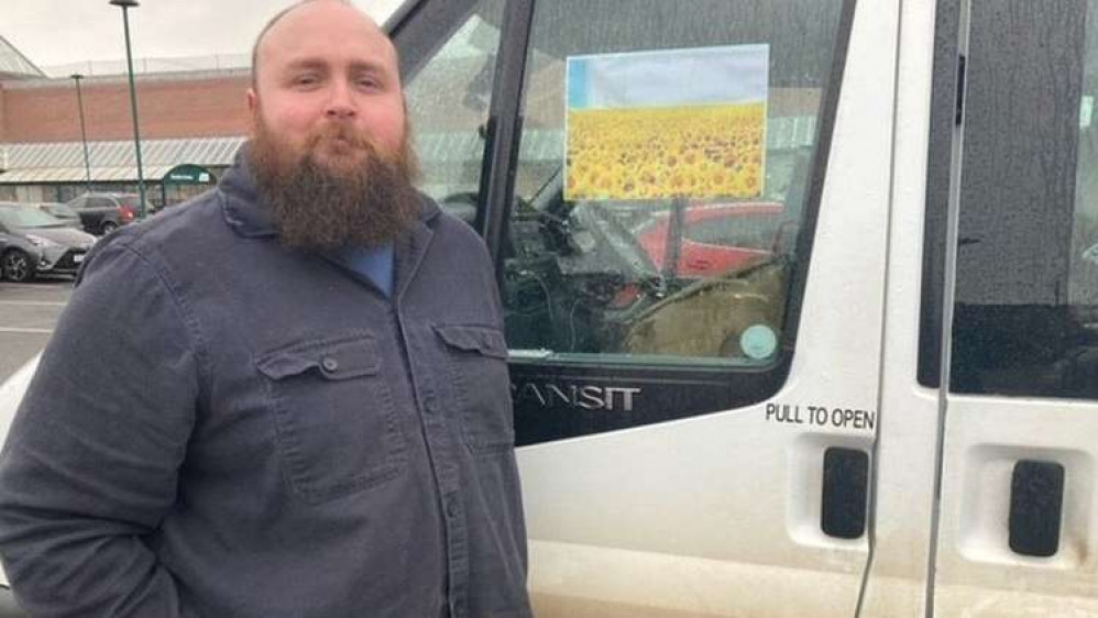 Tom Littledyke pictured with his mini bus en route to the Ukrainian border