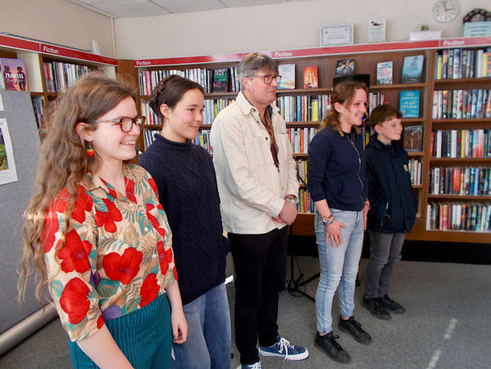 Poetry and art winners Scarlett Timlett-Sheehan, Ethel Short, Faith Boxer and Alex Gibbons with Poet Laureate Simon Armitage in Colyton Library