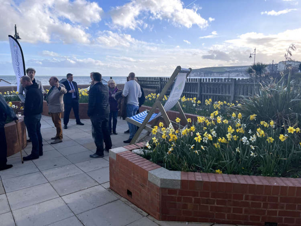 Guests enjoy drinks in the courtyard garden on the seafront