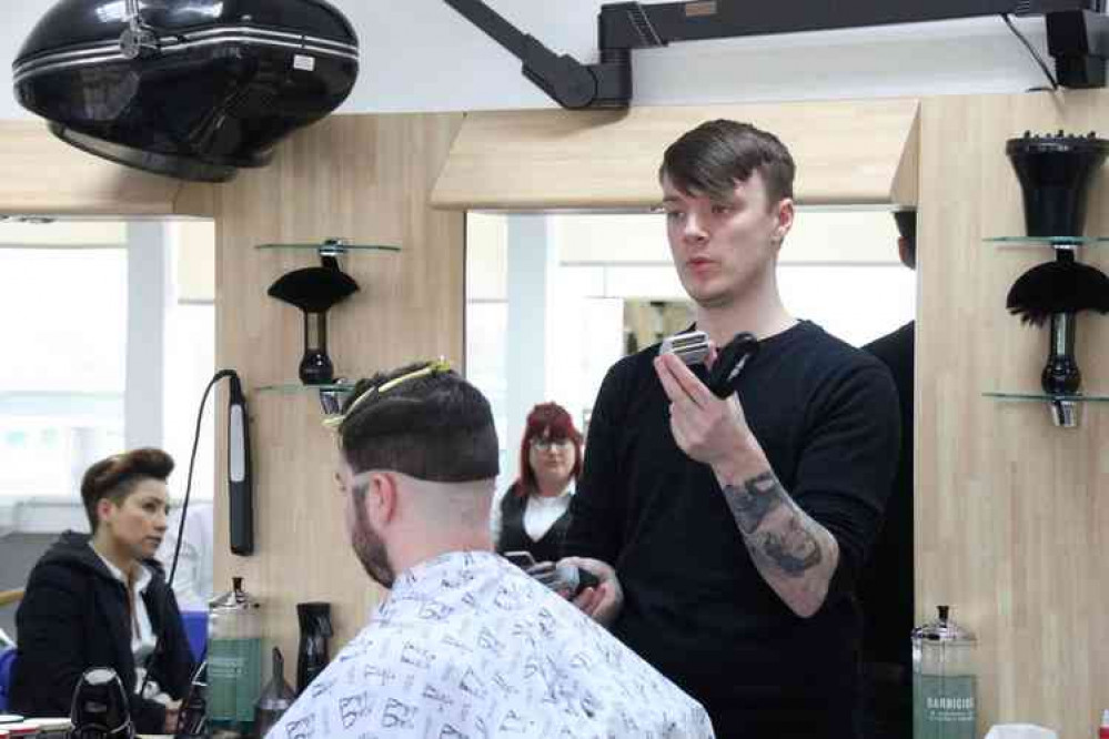 Aiden Fisher giving a barbering demo Aiden Fisher giving a barbering demo