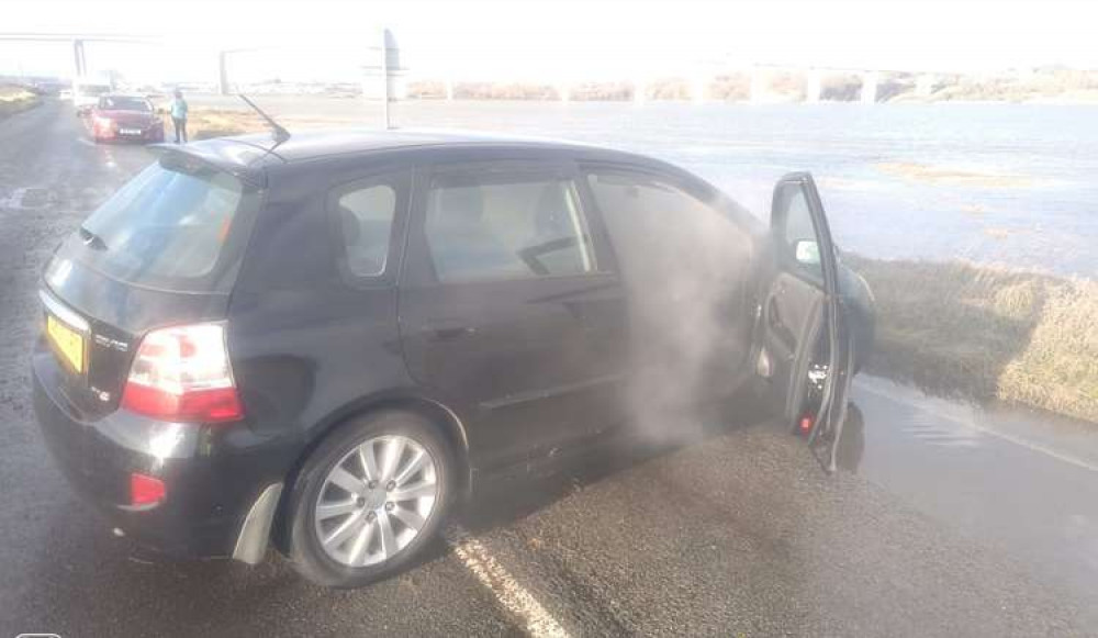 A car starting to catch light after being rescued at the Strand (Picture contributed / Nub News copyright)