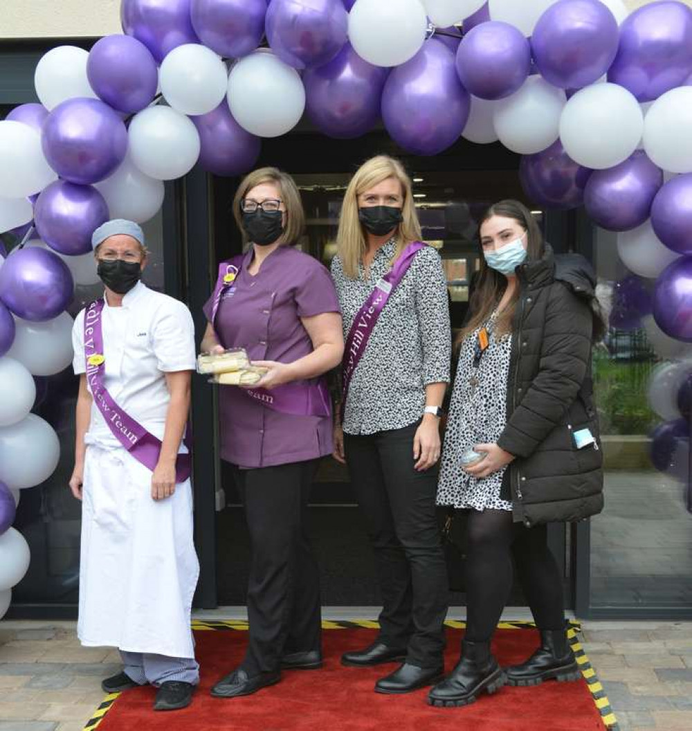 Pictured (L-R): Cadley Hill View's kitchen manager, Jess Miles; laundry assistant, Clare Burchell; and front of house, Steph Scott; with a representative from Sainsbury's