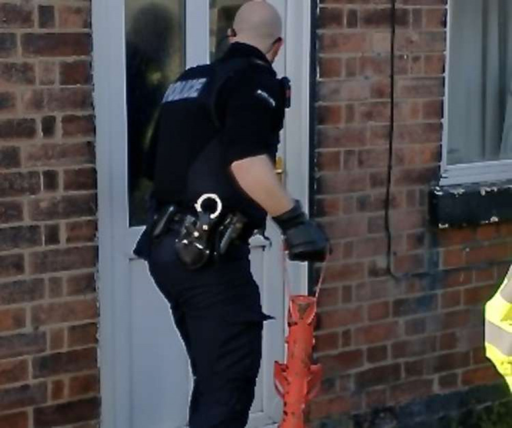 Police execute the drugs raid in Castle Gresley. Photo: Swadlincote SNT