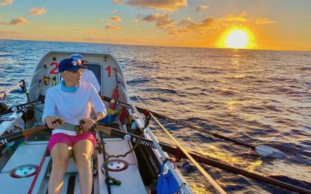 Kat rowing the Dolly Parton at sunrise